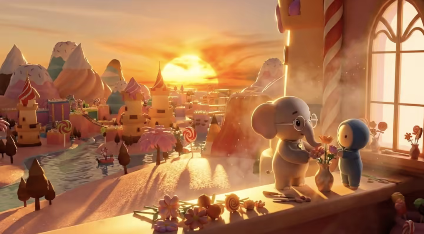 An elephant and a small hooded companion arrange flowers and handmade objects on a sunlit table overlooking a candy-colored town at sunset.